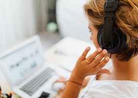 Person in White Shirt Holding Black Headphones